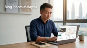 Malaysian business owner reviewing a local listing with map and contact details on a laptop.