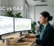 Marketer comparing search data and website conversions on two office screens.