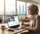 A Malaysian strategist reviews image SEO analytics on a laptop at a bright office desk.