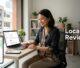 Malaysian business owner checking customer reviews on a laptop beside a phone with map pins.