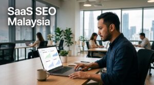 Malaysian SaaS founder viewing search analytics on a laptop in a bright office.