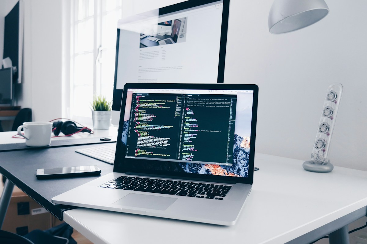 Developer laptop showing code relevant to website rendering and technical SEO checks