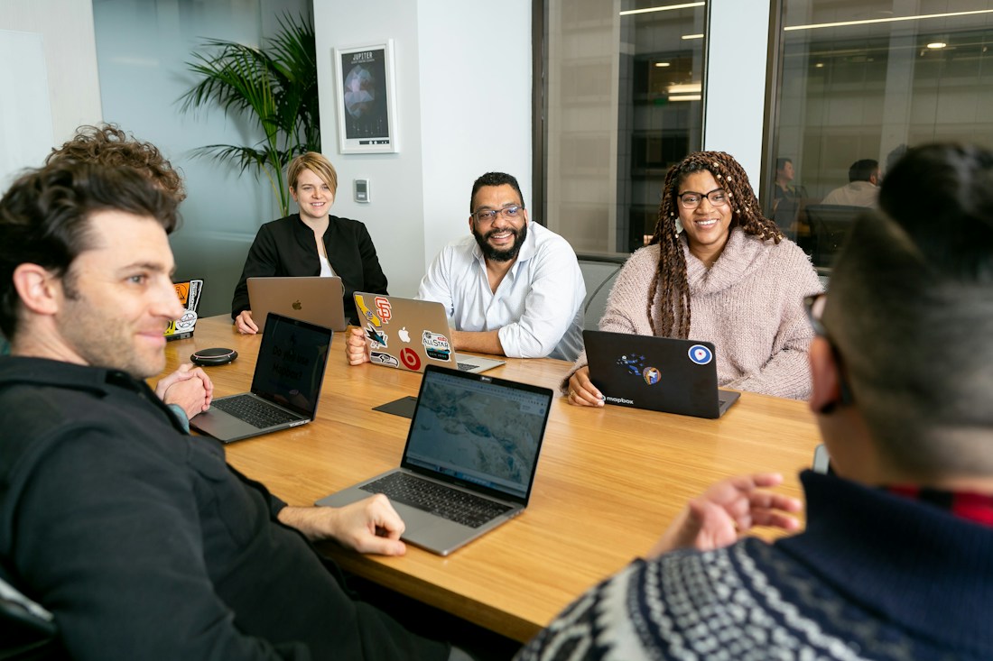 Team reviewing an AI SEO website audit work plan and marketing reports in a meeting