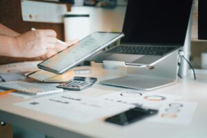 Technical SEO audit workspace with laptop and calculator